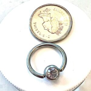 Round Stainless Steel belly ring with cz stone.